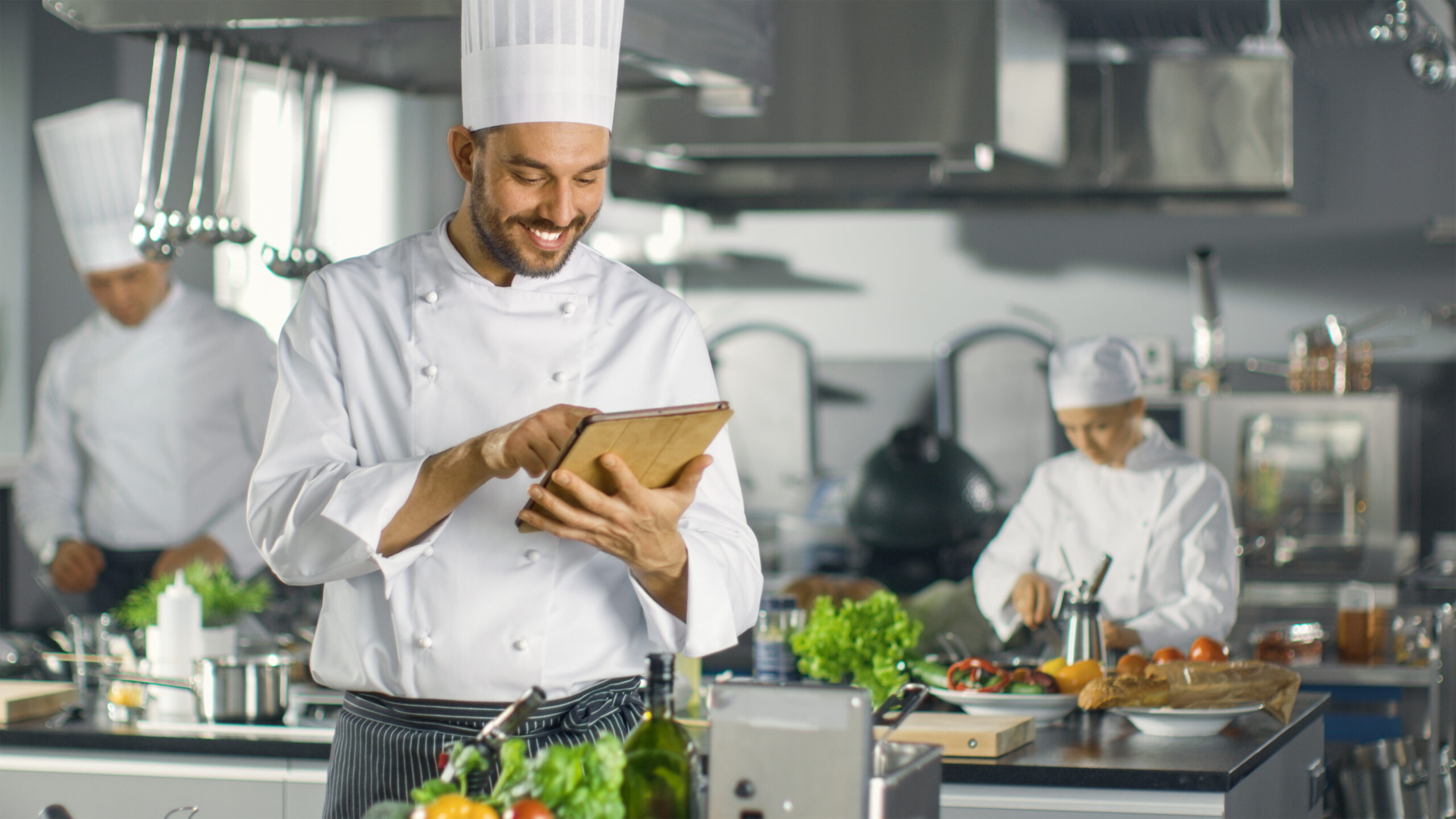 Famous,Chef,Uses,Tablet,Computer,For,Recipes,While,Working,In